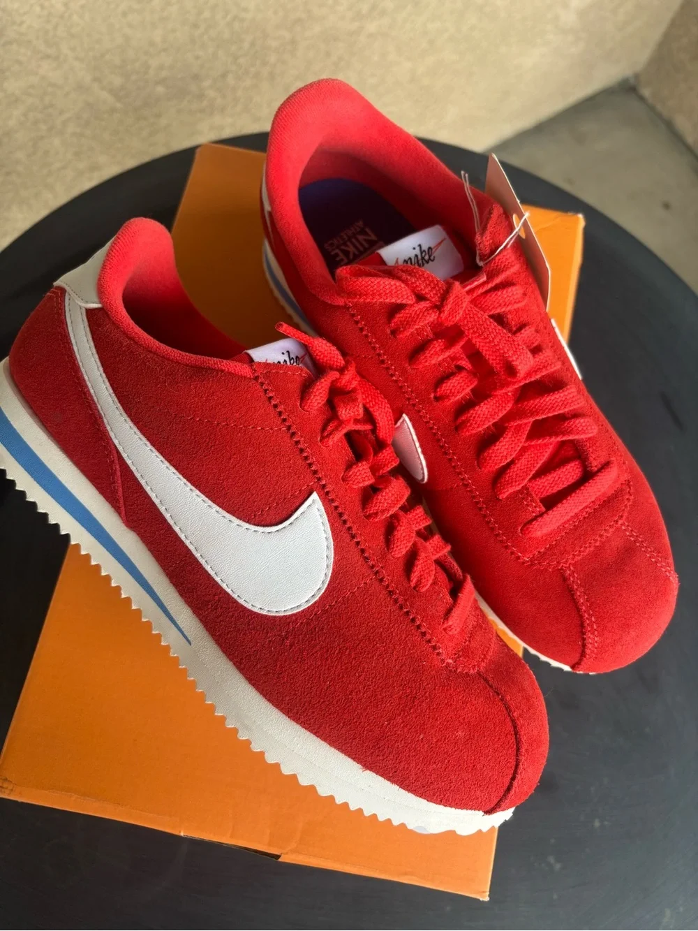 Nike women’s Red Suede Athletic Sneakers with White Swoosh